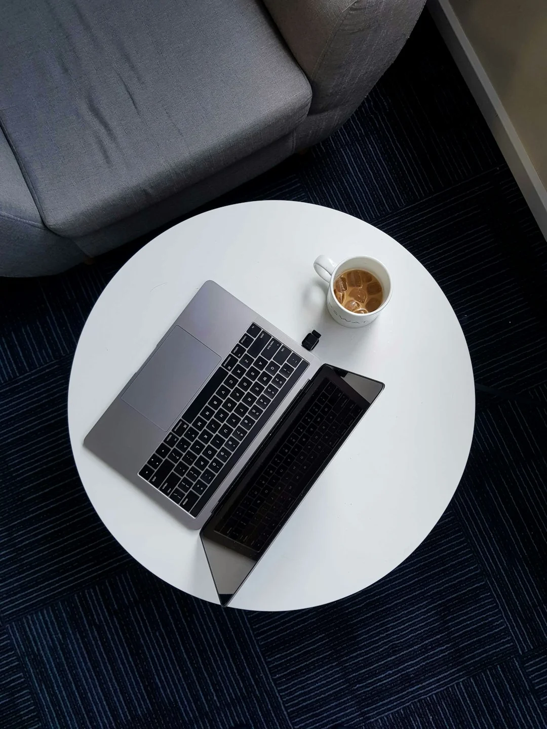 Spacious and contemporary office interior with glass partitions, stylish furniture, and vibrant wall art.